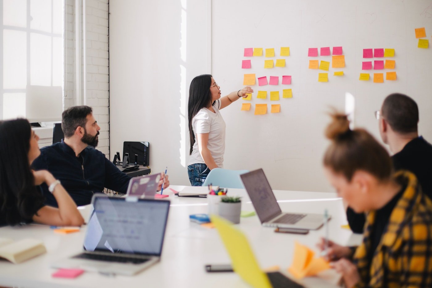 A team running a sprint-planning session at a wall of sticky notes